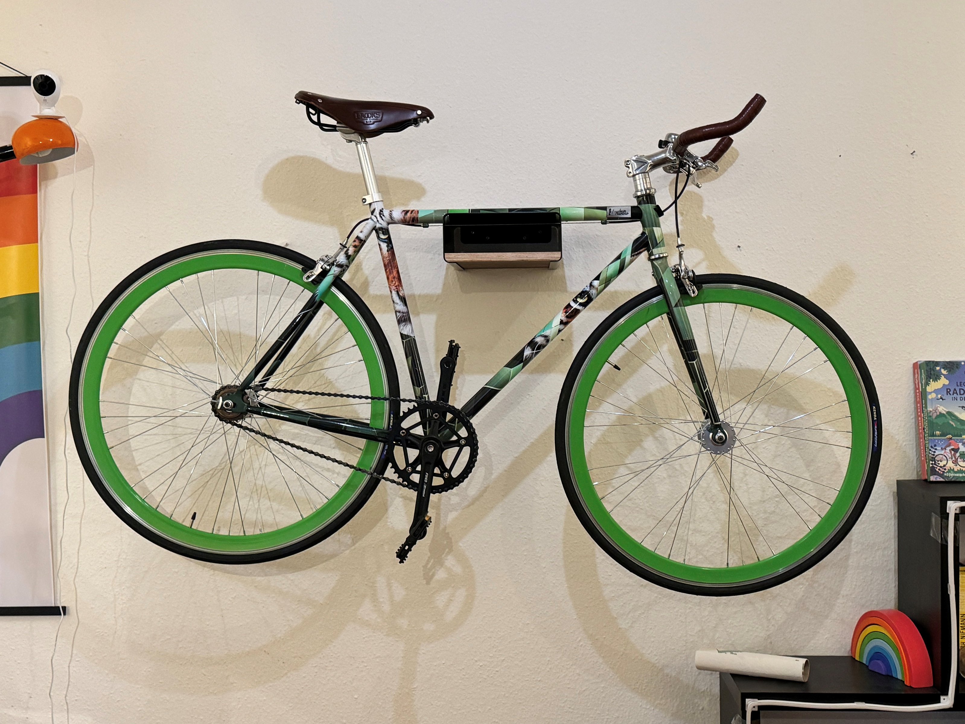 A very green single speed hipster bike with green rims, Brooks saddle and prints of an actual tiger pasted on the frame. Sexy Tigerbike on my wall